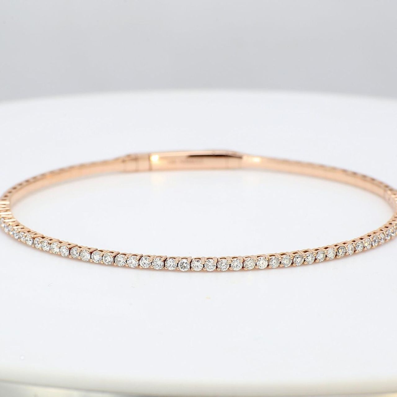 6.50' Lightweight flexible oval bangle in 14K RG with prong set round diamonds.  D1.04ct.t.w.