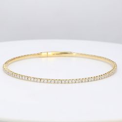 6.50' Lightweight flexible oval bangle with prong set round diamonds.  D1.04ct.t.w.