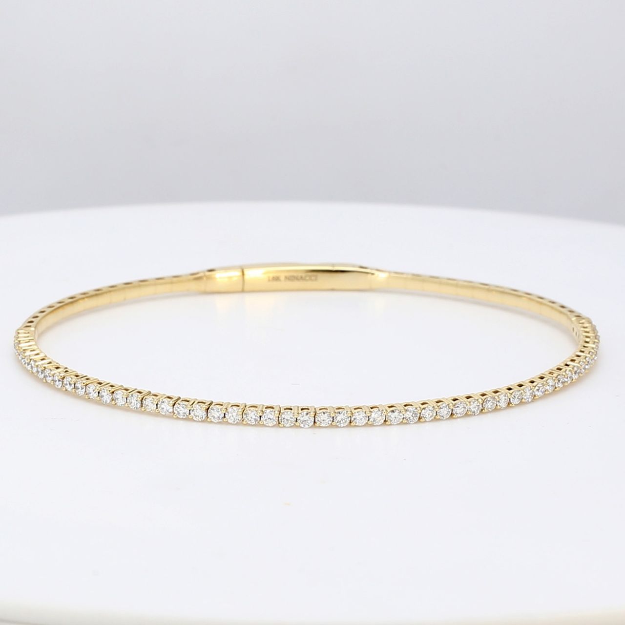 6.50' Lightweight flexible oval bangle with prong set round diamonds.  D1.04ct.t.w.