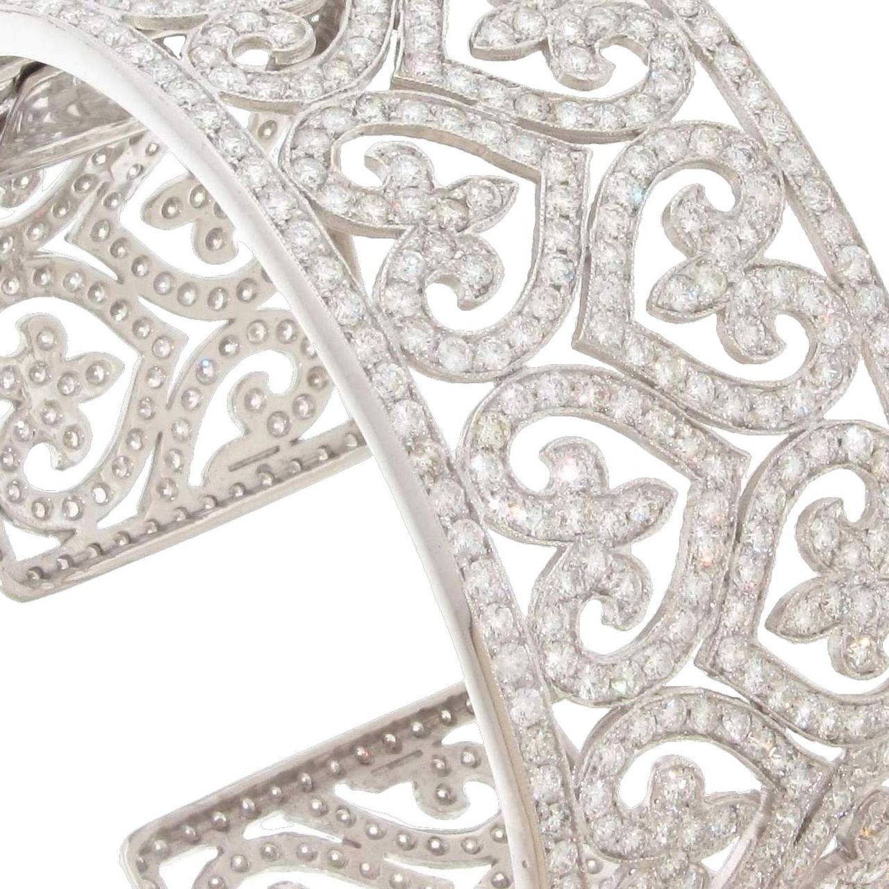 Designer cuff with heart design, milgrain detail, and pave set round diamonds.  D6.55ct.t.w.