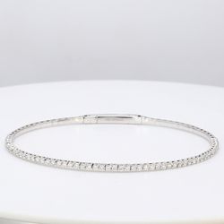 6.50' Lightweight flexible oval bangle with prong set round diamonds.  D1.04ct.t.w.