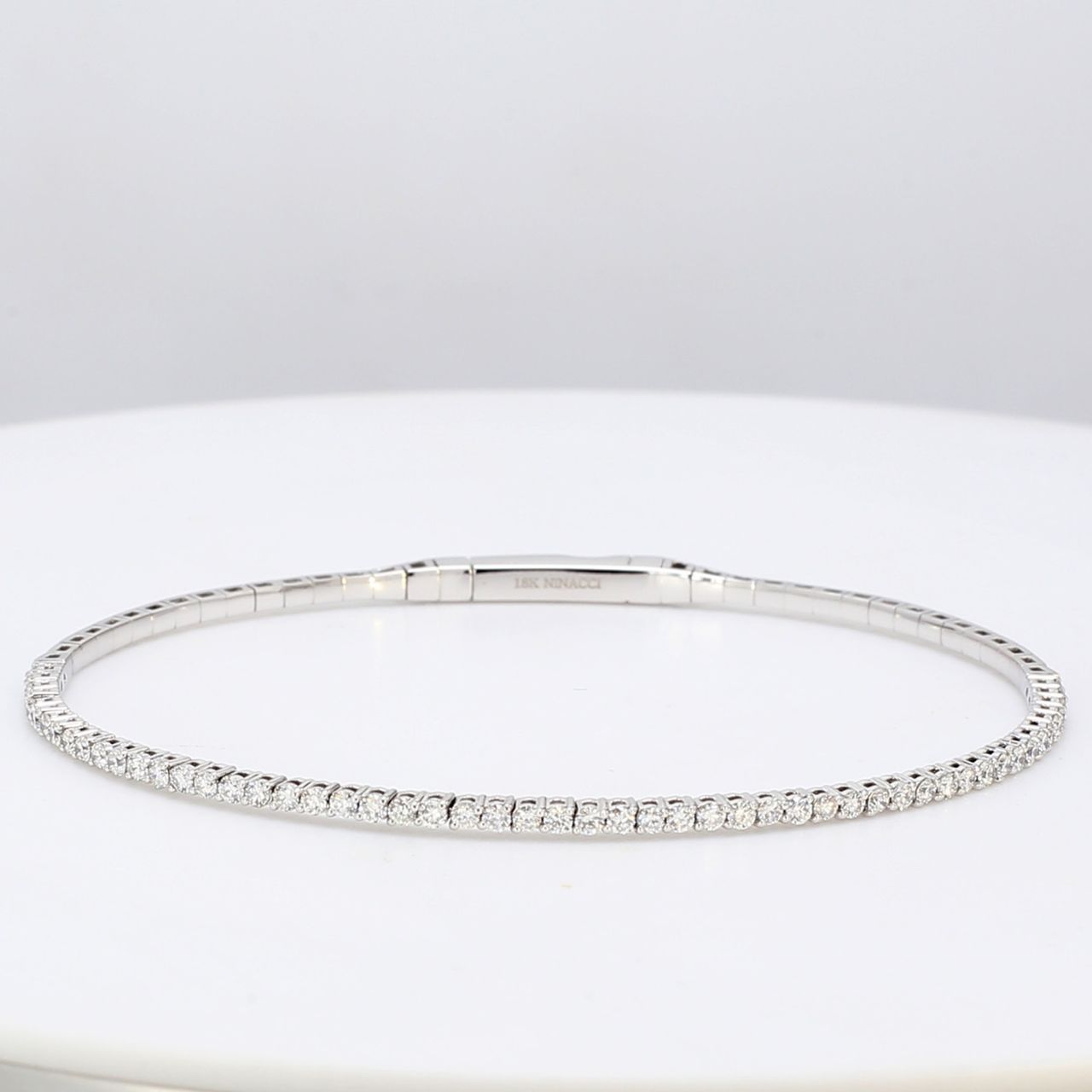 6.5' Lightweight flexible oval bangle in 18K WG with prong set round diamonds.  D1.04ct.t.w.