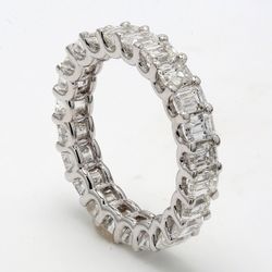 Eternity band in Platinum with U-prong set  24 Emerald cut diamonds. D5.95ct. t.w.   SIZE  7