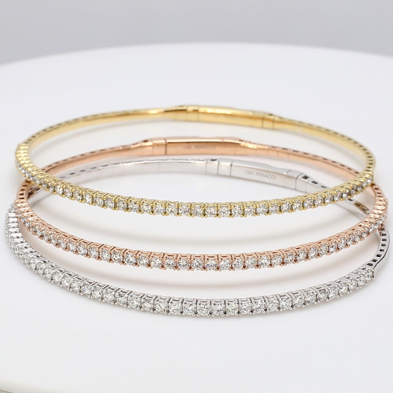 3-piece set light bangle 18K tri-tone with prong set round diamonds.  D3.10ct.t.w.  Size 6.75