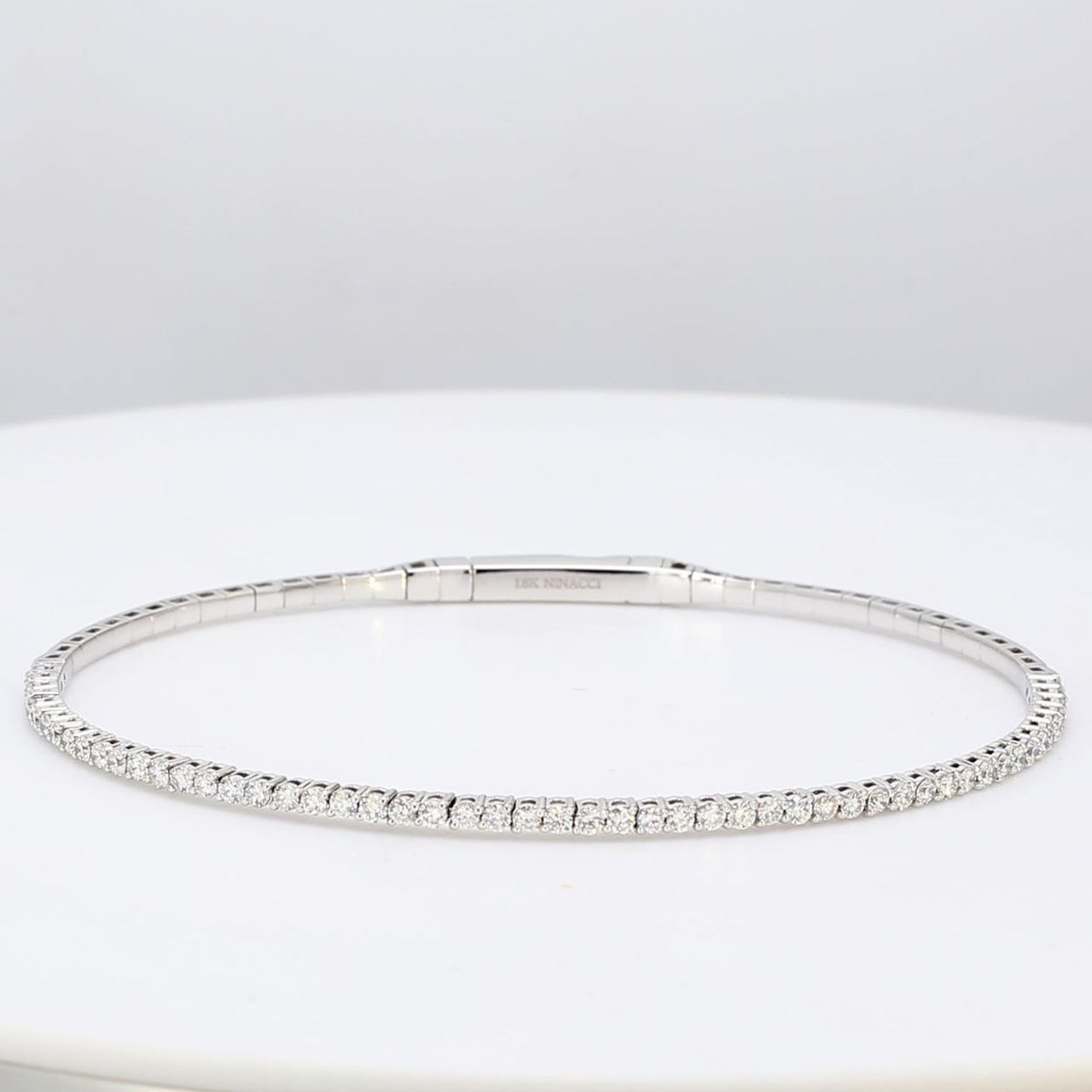 6.75' Lightweight flexible oval shaped bangle in 18K WG with prong set round diamonds.  D1.02ct.t.w.