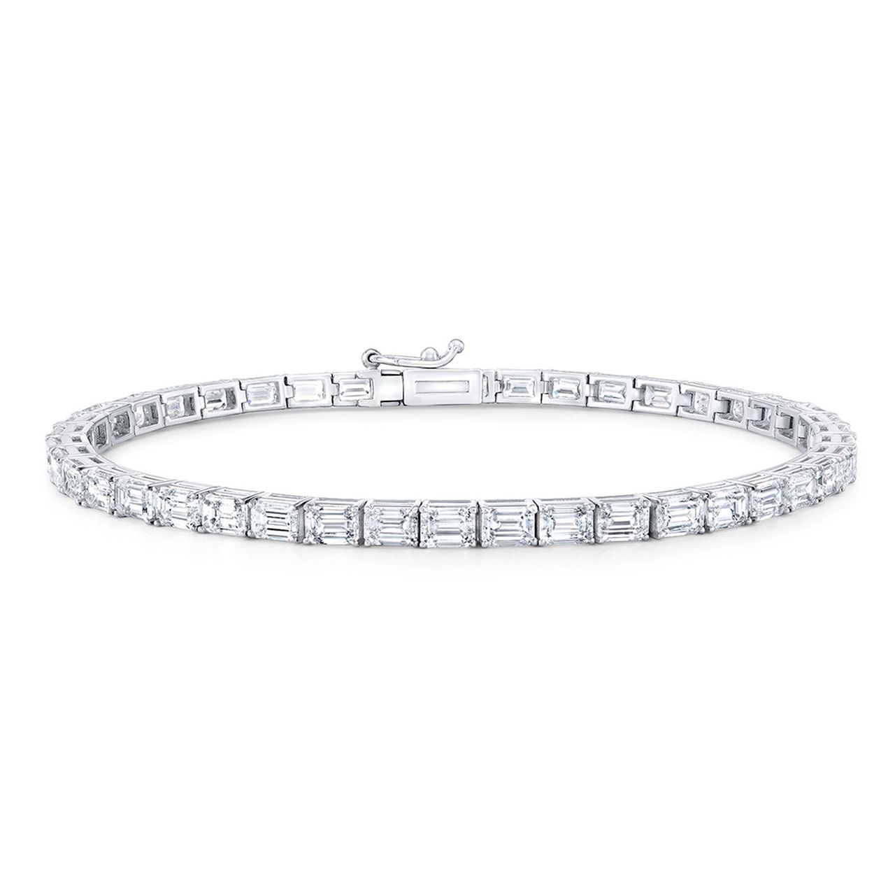 Tennis bracelet east west style in 18K WG with open basket prong set (56) emerald cut diamonds.  D5.29ct.t.w.