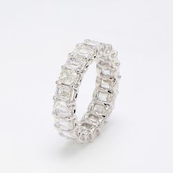 Eternity band in platinum with shared claw U-prong set GIA certified D-F/VVS2-VS2 (19) emerald cut diamonds.  D7.96ct.t.w.  Size 7