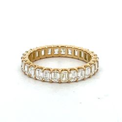 Eternity band in 18K YG with prong set (28) emerald cut diamonds.  D2.48ct.t.w.  Size 6.25