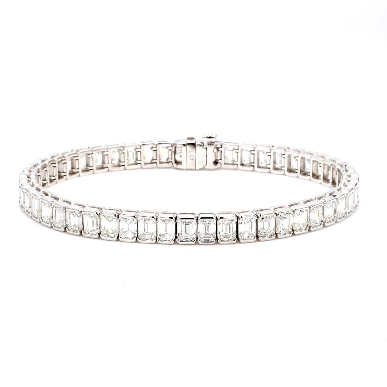 7' Tennis bracelet in platinum with half bezel set (54) emerald cut diamonds.  D13.04ct.t.w.