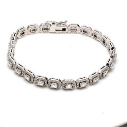 7' Halo tennis bracelet with prong set rounds around emerald cut diamond center stones.  D6.84ct.t.w.