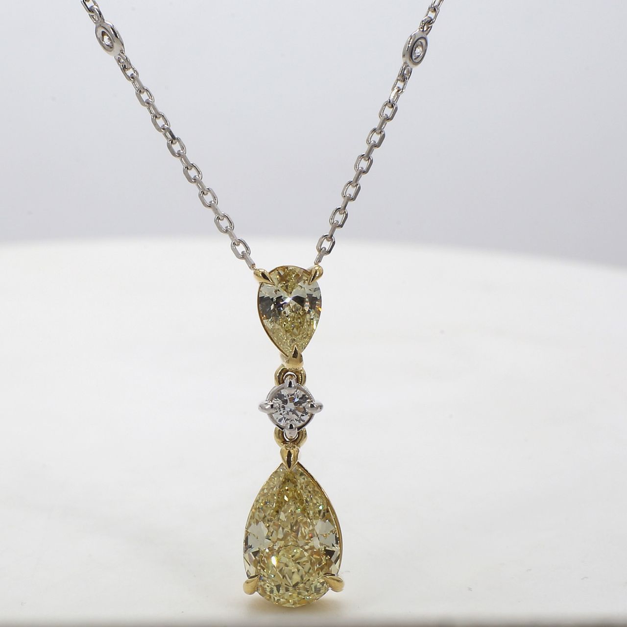 Diamonds by the yard drop necklace in 18K WG with bezel set (10) rounds and prong set FY/IF GIA certified pear diamond center.  D4.06ct.t.w.  (Center - 3.02ct.)