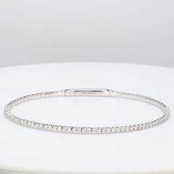 6.75' Lightweight flexible oval shaped bangle in 18K WG with prong set round diamonds.  D1.02ct.t.w.